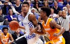 Kentucky's Malik Monk, left, looks for an opening as Tennessee's Jordan Bone (0) defends during the first half of an NCAA college basketball game, Tue