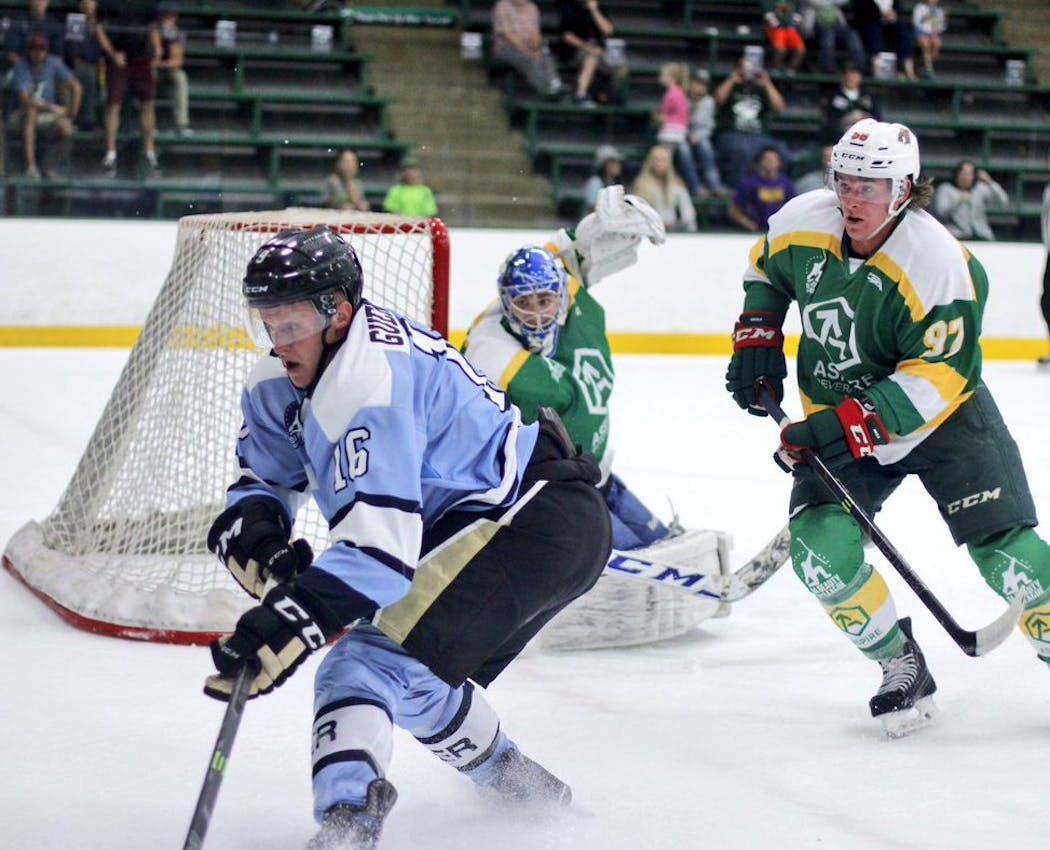 Jake Guentzel is pursued in the corner by the Wild's Erik Haula during Da Beauty League action at Braemar Arena.