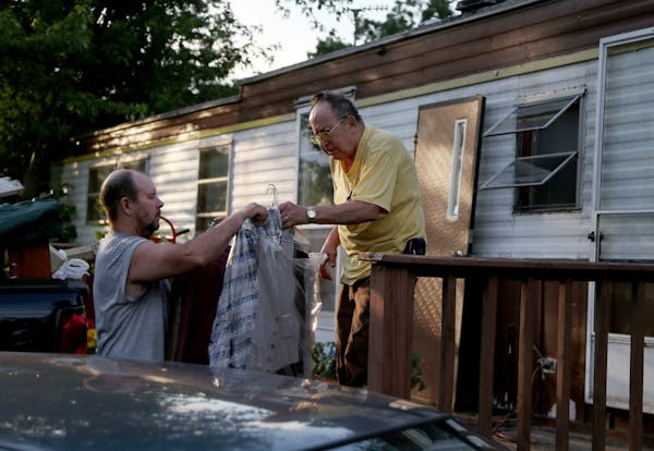 Jerry Wonsewicz, 80, right, gets help moving his belongings from his one Gary Wonsewicz, 57, both residents of Lowry Grove mobile home park on June 30