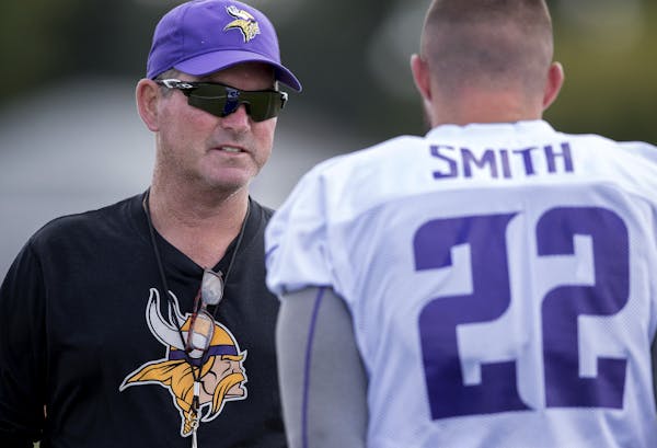 Vikings coach Mike Zimmer, left, speaking with Harrison Smith last week in Mankato, said he and his staff are preparing for a rigorous evaluation of t