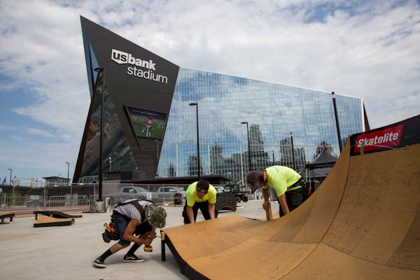From left, Orlando Lopez, Cesar Lutfi and Daniel Oristanio were building a ramp earlier this week outside of the U.S. Bank Stadium for the X Games.