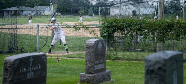 An Atwater player practiced batting in the cages at the Farming Flames Baseball field on Sunday, June 25, 2017 in Farming, Minn. The field butts up ag