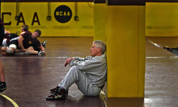 J Robinson watched a practice during his tenure as head coach of the University of Minnesota wrestling team. He now runs a summer camp at the Universi