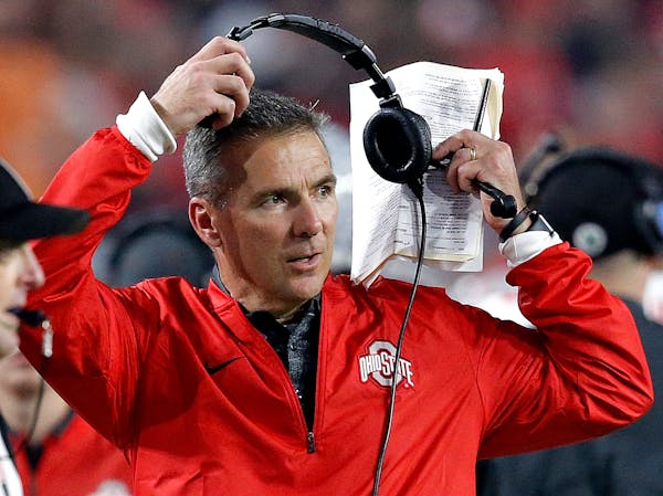 Ohio State head coach Urban Meyer takes off his headset during the second half of the Fiesta Bowl against Clemson