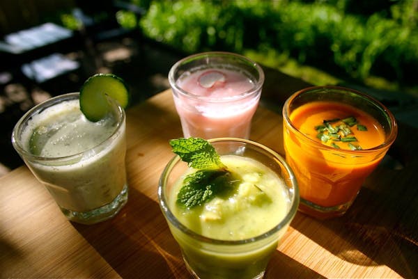From left to right: Cold Cream of Cucumber With Dill and Yogurt. Grape Gazpacho (front). Radish Buttermilk Soup (back). Chilled Carrot Soup With Fines