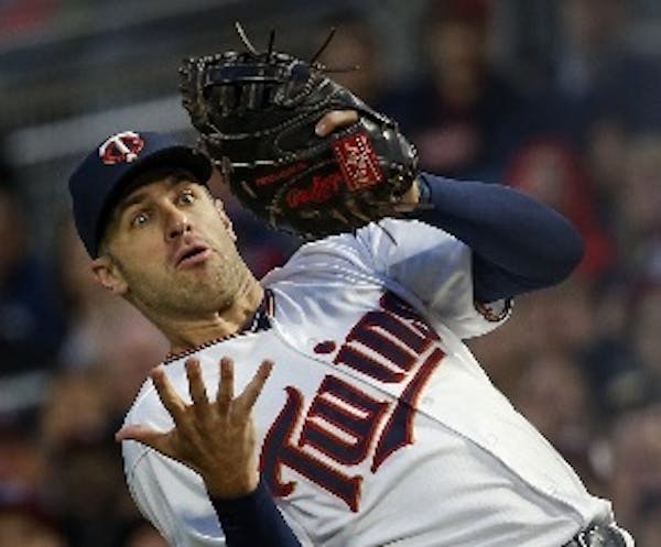 Twins first baseman Joe Mauer reacted after dropping a foul ball for his first error of the year.