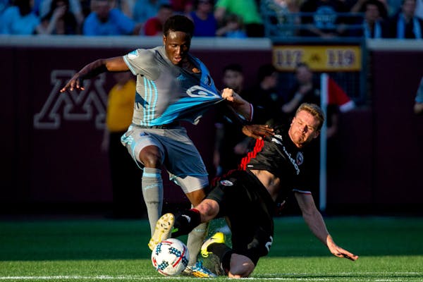 D.C. United's Taylor Kemp, right, grabs Minnesota United forward Abu Danladi's jersey during the first half on Saturday, July 29, 2017, at TCF Bank St