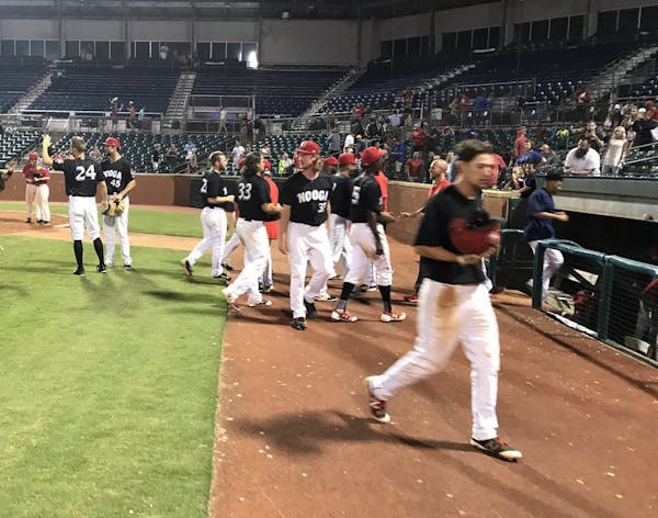 Members of the Chattanooga Lookouts celebrated after their 21-inning victory over Birmingham on Sunday.