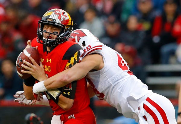 FILE - In this Nov. 7, 2015, file photo, Maryland quarterback Perry Hills, left, is sacked by Wisconsin linebacker Jack Cichy in the first half of an 