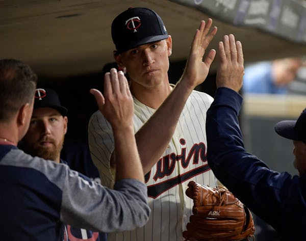 Minnesota Twins starting pitcher Aaron Slegers (50) was high fived by teammates and the coaching staff after being pulled from the game in the top of 