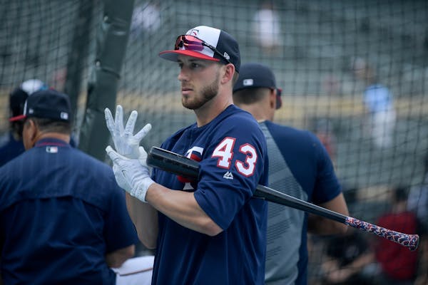 Minnesota Twins catcher Mitch Garver (43) adjusted his gloves during batting practice Friday.