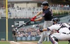 Cleveland Indians' Jay Bruce hits a two-run single off Minnesota Twins pitcher Kyle Gibson in the first inning of game one of a double header baseball