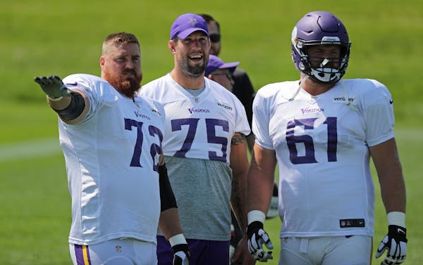 Vikings left guard Alex Boone (75, between fellow linemen Mike Remmers and Joe Berger) had his left knee wrapped at Tuesday's practice at Winter Park.