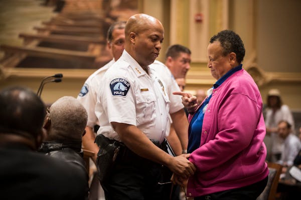 New Minneapolis Police Chief Medaria Arradondo chatted with Debby Montgomery, the first female officer in the St. Paul Police Department and former St