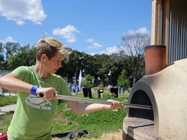 Elliot Cooper cooked pizzas in the wood fire grill at Frogtown Farm. The Minnesota Super Bowl Host Committee is giving $50,000 to St. Paul’s Frogtow