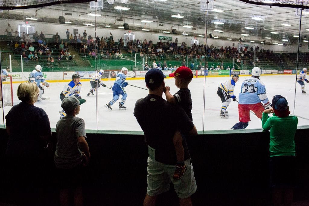 Fans watch the RBC team against Walser from along the glass.