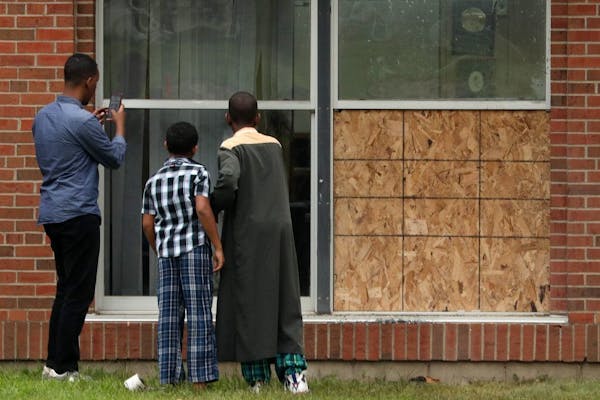 A group of boys stopped Saturday to survey the damage at the Dar Al Farooq Islamic Center in Bloomington caused by an early morning bombing.