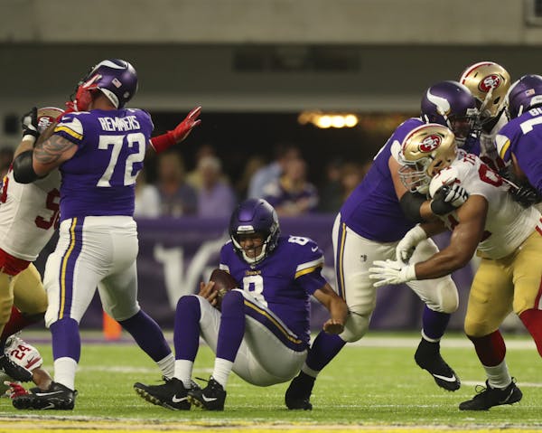 Vikings quarterback Sam Bradford was sacked for an 8-yard loss by 49ers defensive end Elvis Dumervil in the first quarter Sunday.