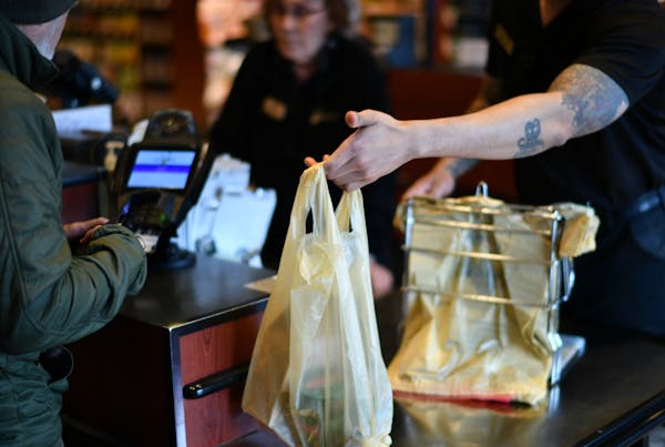 Kowalski's customers in southwest Minneapolis are given a choice of paper or plastic grocery bag.