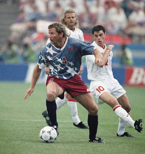 The 1994 World Cup — with America’s Cle Klooman and Switzerland’s Ciriaco Sforza shown — was held in the U.S., in part, as a way to help build