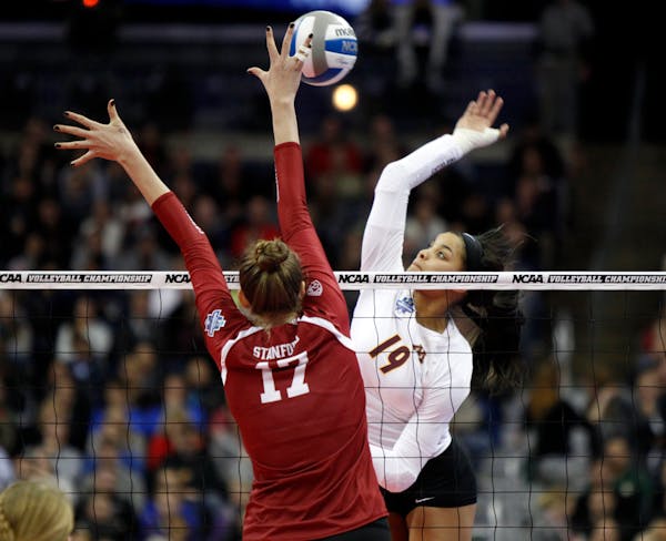 Outside hitter Alexis Hart (in white) and the Gophers moved from No. 2 to No. 1 in this week’s American Volleyball Coaches Association poll, reachin