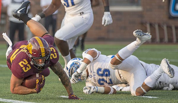 Gophers running back Shannon Brooks fell inches short of the end zone as he was stopped by Buffalo safety Ryan Williamson during the first quarter. Th
