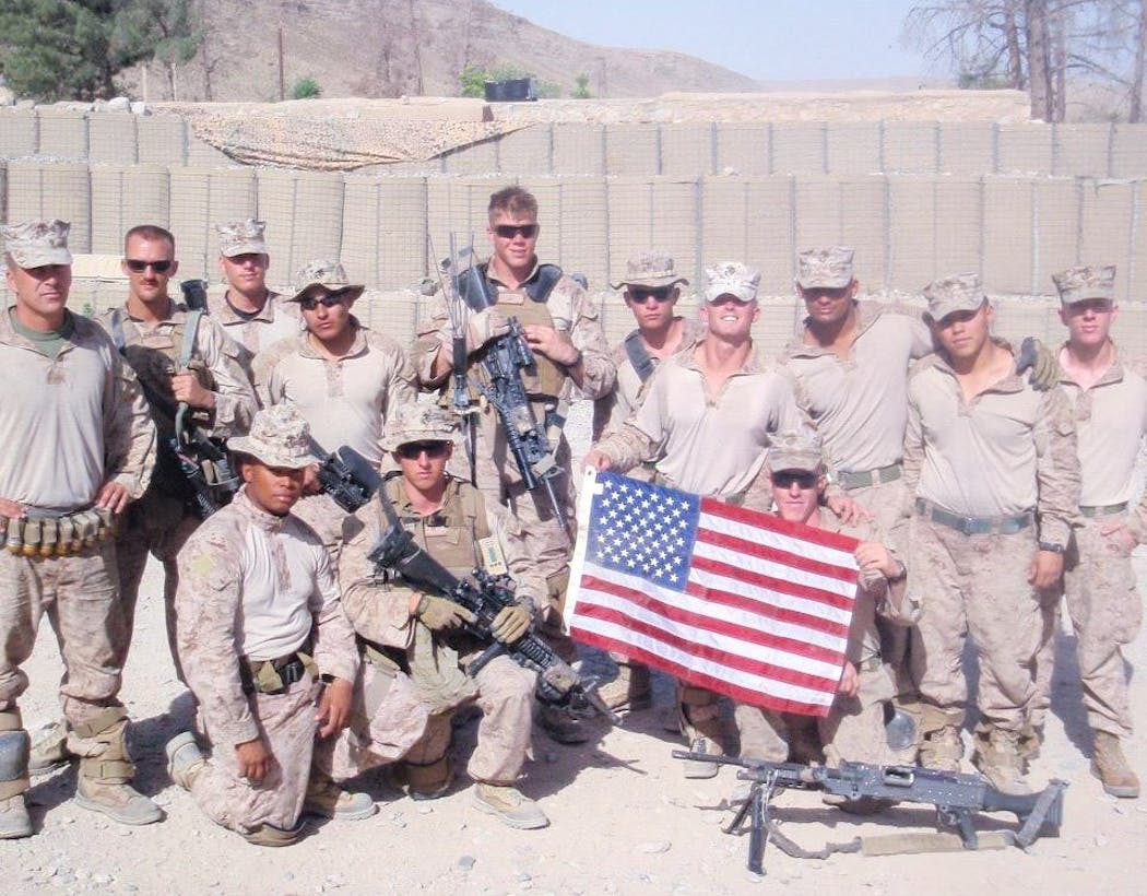 Levi Minissale (kneeling center) with his squad of Marines in Afghanistan in 2011. 