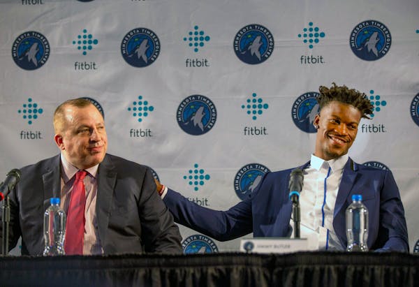 Minnesota Timberwolves new point guard Jimmy Butler, right, pats Timberwolves head coach Tom Thibodeau on the back during a press conference at Mall o
