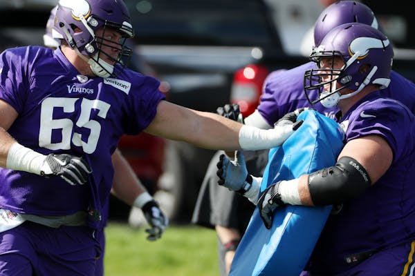 Minnesota Vikings center Pat Elflein (65) tackled a bag held by Minnesota Vikings center Nick Easton (62) during practice Tuesday.