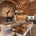 The great room’s curved timbers, reclaimed barn wood and Montana stone fireplace. A built-in bar for entertaining is on the far wall.