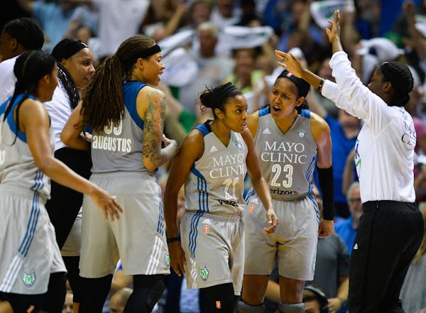 Teammates celebrated around Minnesota Lynx guard Renee Montgomery (21) after her buzzer beater to end the third quarter Tuesday night against the Wash