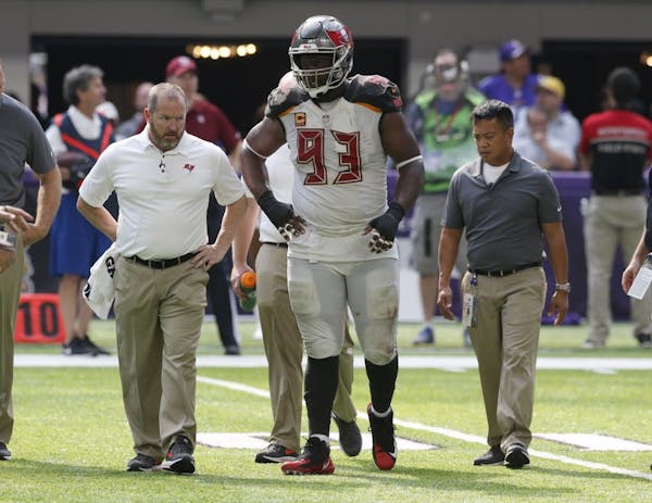 Tampa Bay Buccaneers defensive tackle Gerald McCoy (93) is helped off the field after getting injured during the second half of an NFL football game a