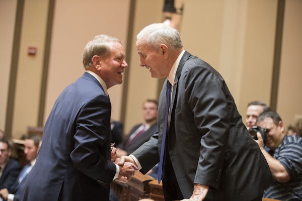 Gov. Mark Dayton, right, greets Doug Kelley, the lawyer representing the Minnesota State Legislature, before the oral arguments begin.