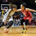 Minnesota Lynx guard Seimone Augustus (33) moved the ball toward the basket while being defended by Washington Mystics guard Kristi Toliver (20) in th