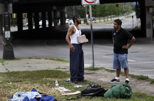 A street outreach worker from St. Stephen's Human Services with a homeless man near Hennepin and Lyndale avenues on the edge of downtown in 2012. The 