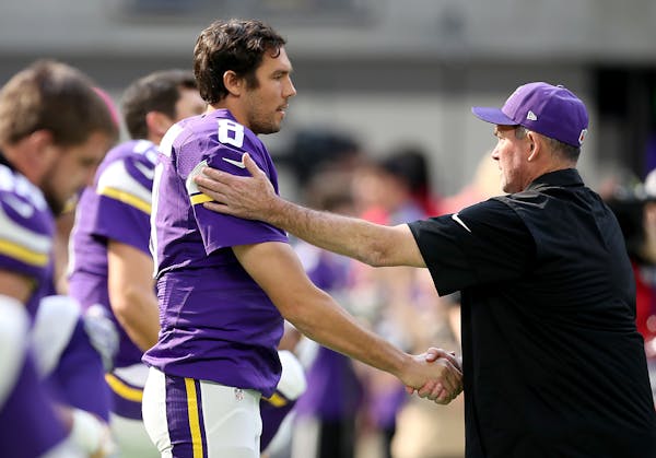 Vikings quarterback Sam Bradford is greeted by head coach Mike Zimmer last season.