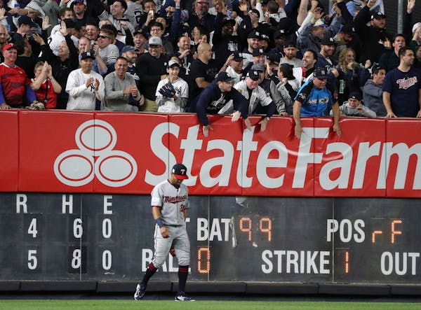 Twins left fielder Eddie Rosario hung his head after he was unable to grab a two-run home run hit by New York Yankees right fielder Aaron Judge (99) i