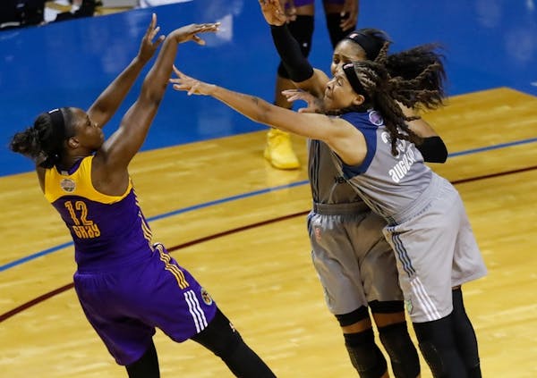 Los Angeles Sparks guard Chelsea Gray (12) shoots the game-winning shot as Minnesota Lynx forward Maya Moore (23) and guard Seimone Augustus (33) appl