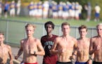 Khalid Hussein center (with shirt on) and Grant Price (far right ) and other members of the Wayzata high cross county team worked out at Wayzata High 