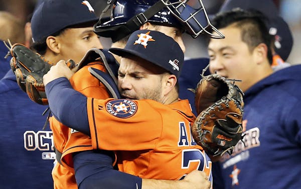 Catcher Jason Castro, center left, embraced Astros second baseman Jose Altuve after the Astros beat the New York Yankees 3-0 in the 2015 AL wild-card 