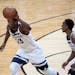 Minnesota Timberwolves guard Jimmy Butler (23) moved the ball down the court in front of fellow guard Jeff Teague (0) in the second quarter Saturday.