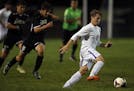 Zack Aday-Nicholson(10) is chased by Jake Schumacher(5) of Apple Valley.] Eastview's boys' soccer team will be hosting Park of Apple Valley at the hig