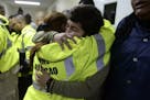 Rescue team members Candida Lozada, left, and Stephanie Rivera, right, hug as they share their frustration over being unable to go out to answer sever