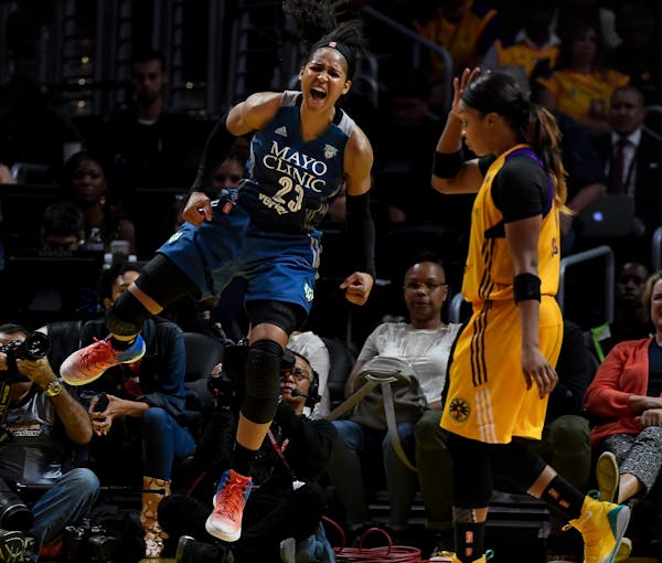Lynx forward Maya Moore celebrates after a layup while being fouled by Los Angeles Sparks forward Candace Parker in the fourth quarter of Game 4