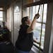 Tasha Julius, production manager for the nonprofit Sustainable Resource Center, measured windows for replacements at the home of Braulia Rendon.