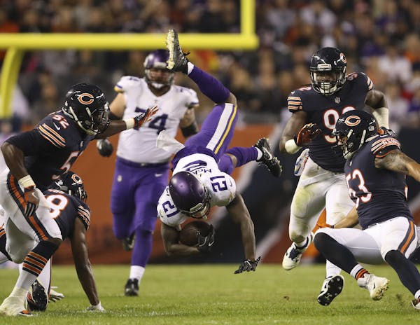 Vikings running back Jerick McKinnon was upended by Bears strong safety Adrian Amos (38) after a short pass reception in the first half. McKinnon late