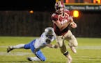 Northfield quarterback Lars Prestemon scrambles for some yards Friday against Owatonna in the first quarter at Memorial Field in Northfield. The fifth