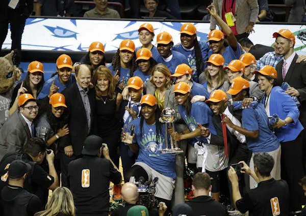 The Lynx pose with the trophy for pictures as they celebrated their WNBA finals win against the L.A. Sparks at Williams Arena on Wednesday, October 4,