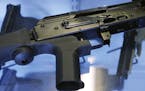 A little-known device called a "bump stock" is attached to a semi-automatic rifle at the Gun Vault store and shooting range Wednesday, Oct. 4, 2017, i
