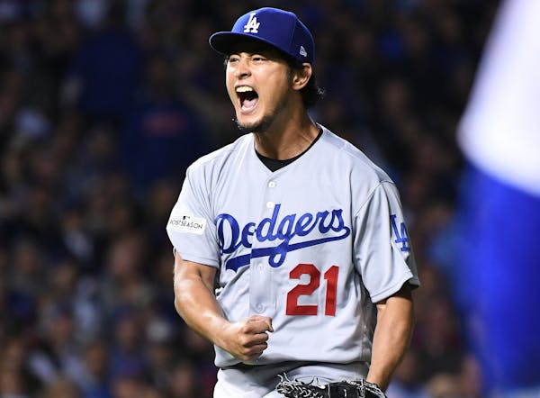 Los Angeles Dodgers pitcher Yu Darvish celebrates after the Chicago Cubs' John Jay grounded into a double play in the sixth inning during Game 3 of th